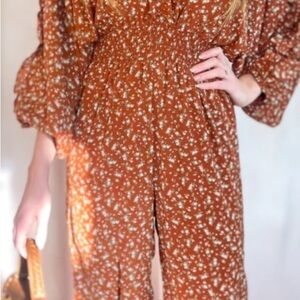 Storia
Boutique rust colored floral jumpsuit
